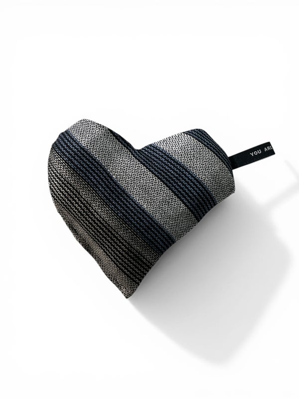 Small heart-shaped warming pillow in striped blueand black with white and beige